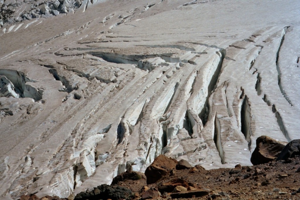 Shear or herring-bone crevasses on the Emmons Glacier; such crevasses often form near the edge of a glacier where interactions with underlying or marginal rock impede flow. In this case, the impediment appears to be some distance from the near margin of the glacier. 